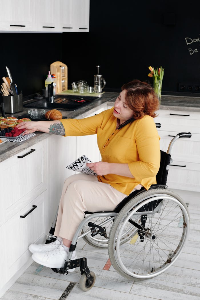 Woman in Yellow Long Sleeve Shirt Sitting on Wheelchair