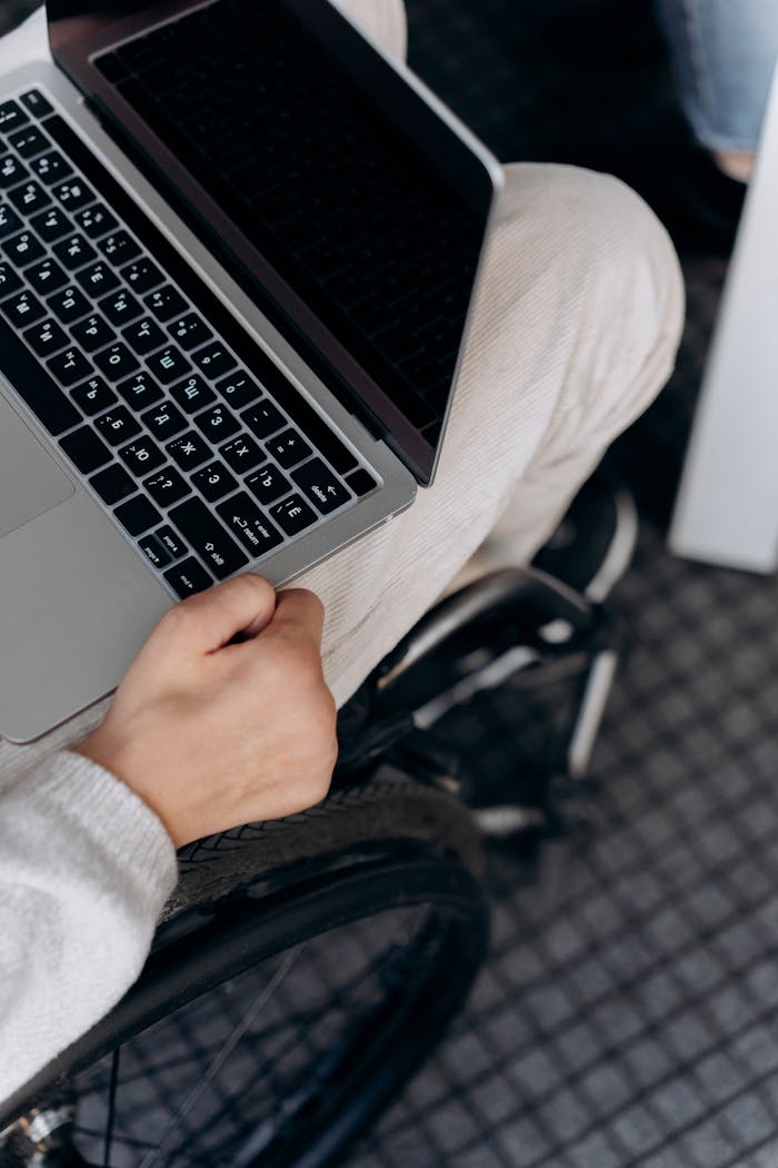 A Person in a Wheelchair Using a Laptop