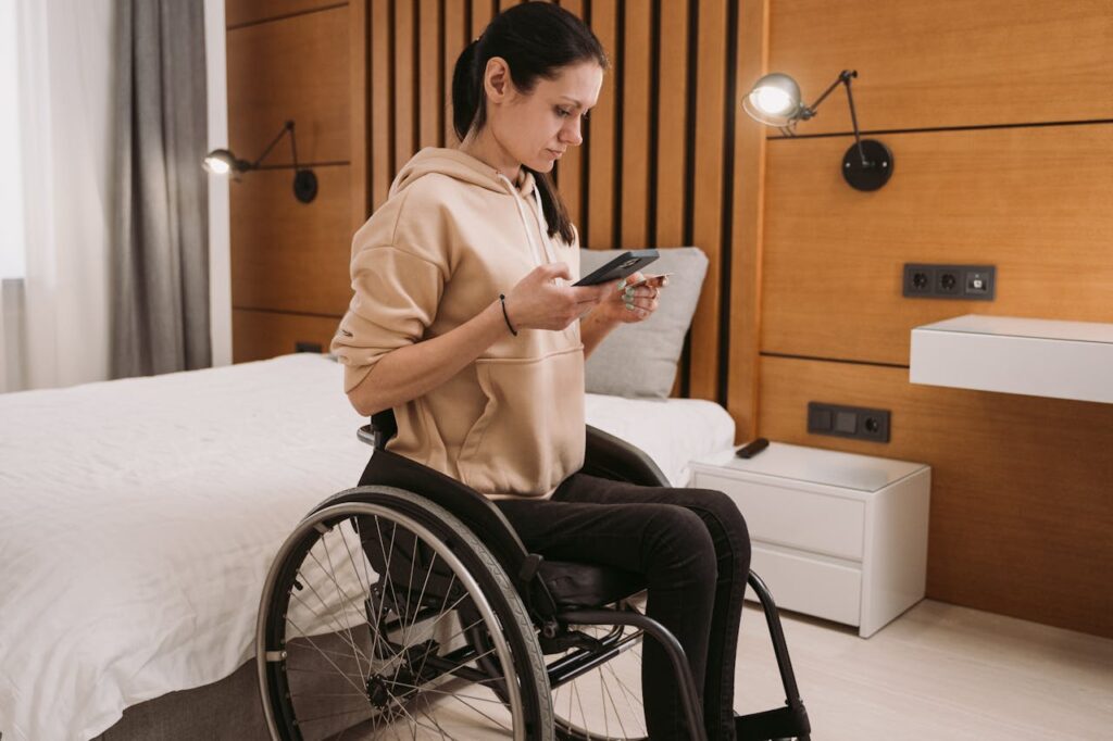 A Woman on a Wheelchair Holding a Smartphone 