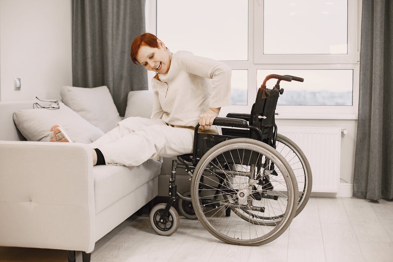 Woman Moving from Wheelchair to Bed